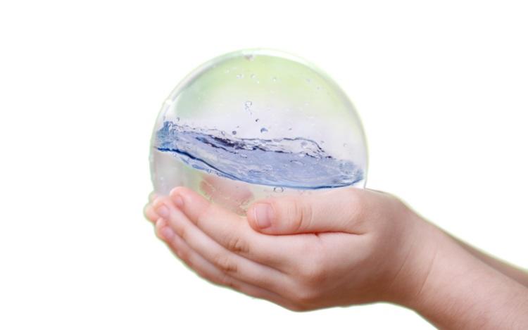 Hands holding ball of water